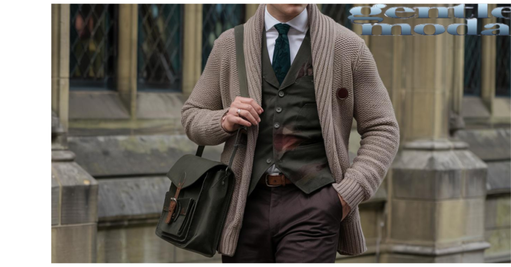 man in dark academia fashion. He is wearing a beige cardigan with a dark green vest over it.